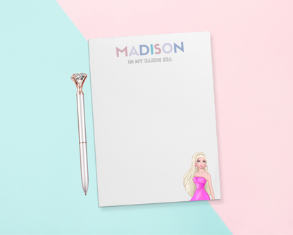 We all know that person who loves Pop culture! Give a thoughtful and useful gift for someone to stay organized. Personalized notepads are exactly the gift they’d love. Choose the color combination for the recipient's name and custom slogan below - such as "in my Barbie era".