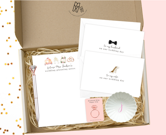 Personalized engagement stationery gift set. Comes with a large wedding planning notepad and a set of "to my husband/wife" cards with envelopes. Personalized initial ring dish and diamond ring paper clip. It's going to make their day!